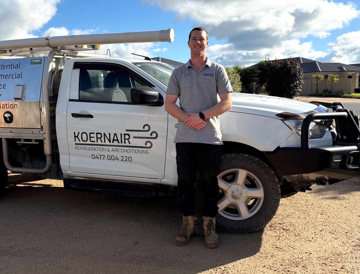 Koernair technician standing beside a service vehicle